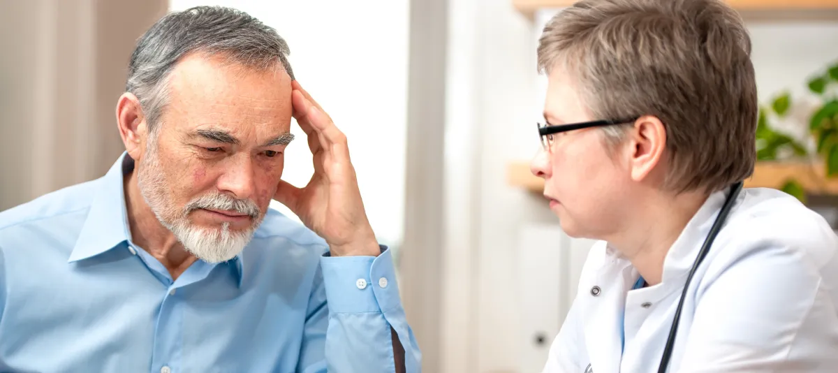 An elderly man discussing health concerns with a doctor.