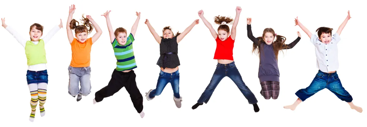 A group of seven children are jumping into the air with their arms raised, showing various expressions of excitement and joy.