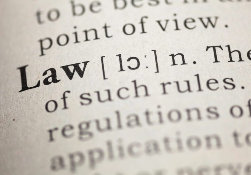 Close-up image of a dictionary page showing the word "Law," its pronunciation, and part of its definition. The word is bolded and prominently displayed.
